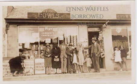 Harry Cowls and his brother Bert Cowls (sons of Harry) with their newsagent shop in Porthleven.